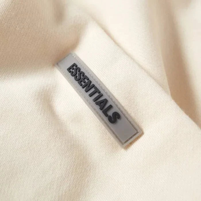 Close-up of the Essential tag on a hoodie, showcasing the premium quality and branding details.